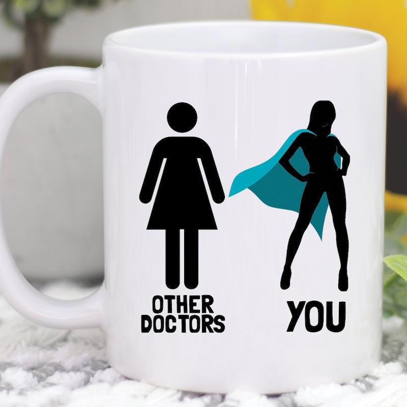 Tailorly White Ceramic 11 oz Mug - Other Doctors You Powerful Female Silhouette Wearing A Vibrant Teal Cape Proudly Standing Hero