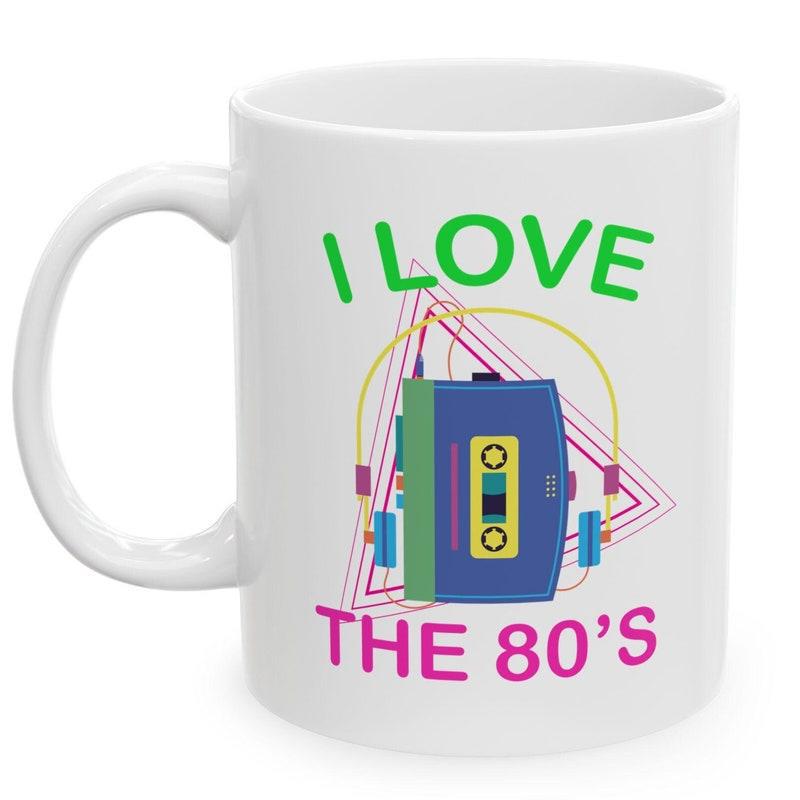 Tailorly White Ceramic 11 oz Mug - I Love The 80s Retro Blue Portable Music Device Among Vibrant Neon Geometric Shapes Background Cassette Player