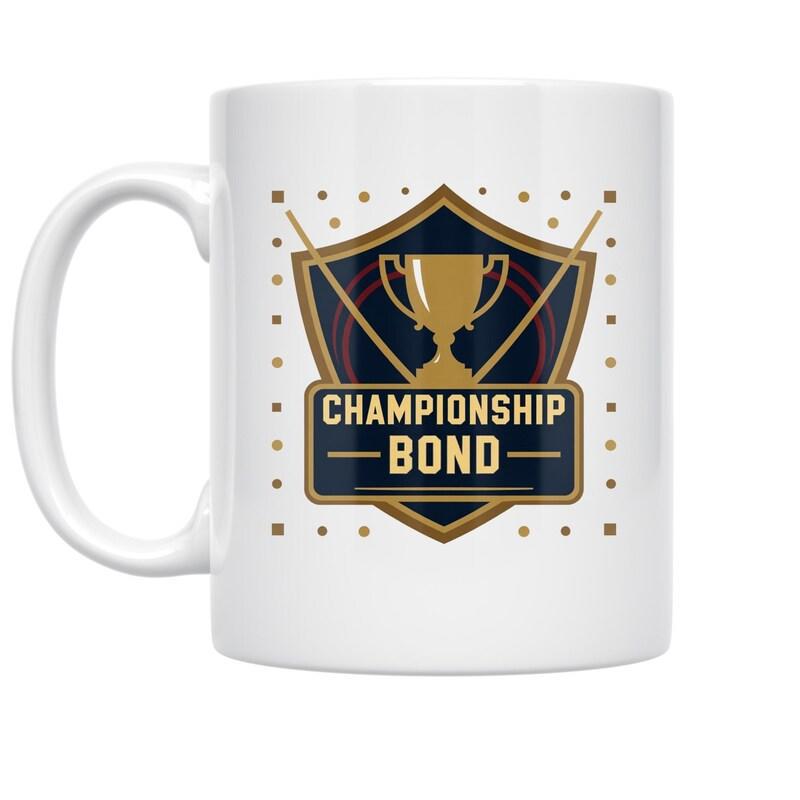 Tailorly White Ceramic 11 oz Mug - Championship Bond Classic Shield Featuring Golden Trophy Cup Among Decorative Square Accents Trophy