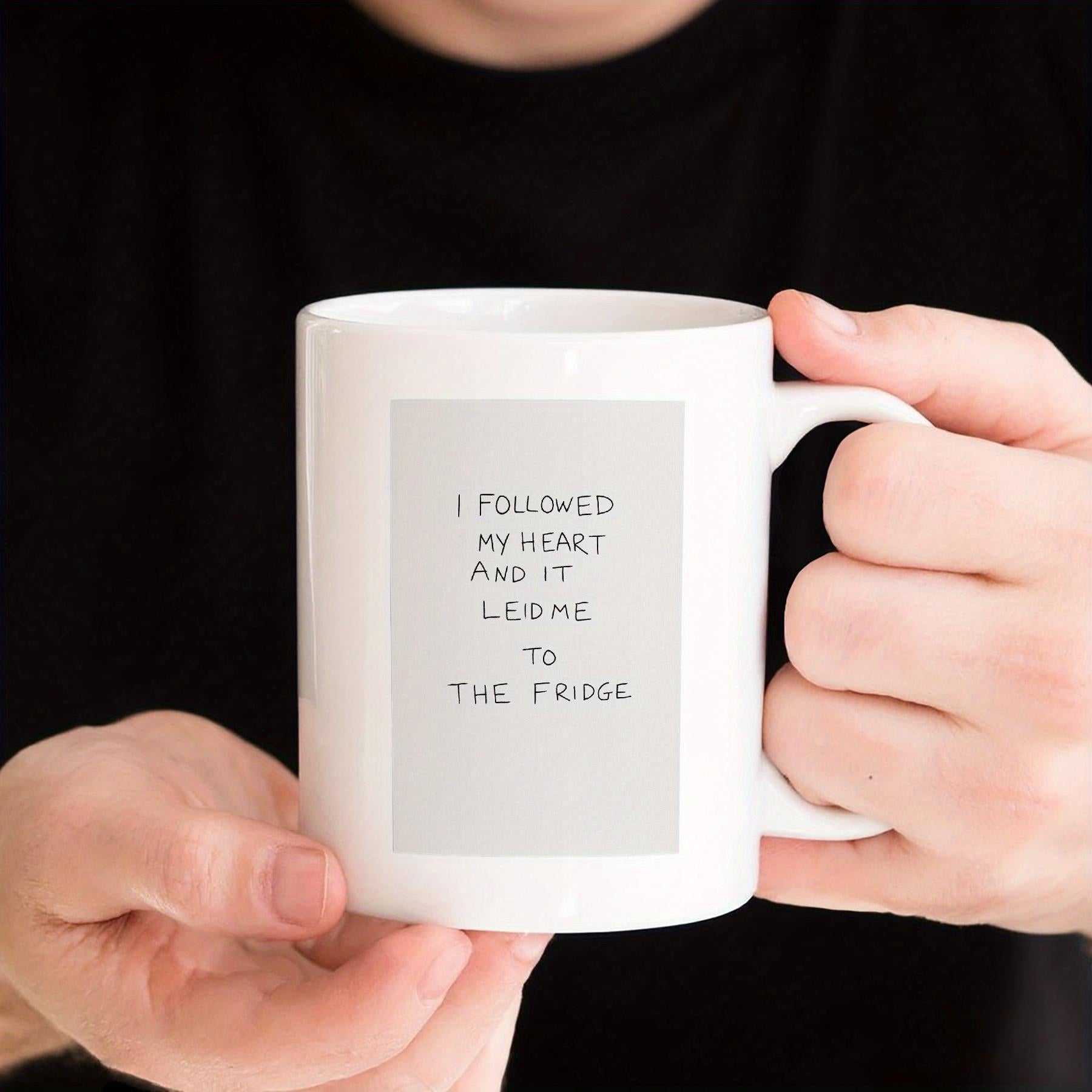 Tailorly White Ceramic 11 oz Mug - I Followed My Heart And It Led Me To The Fridge Minimalist White Ceramic Design Held By Hands Against Dark Background Mug