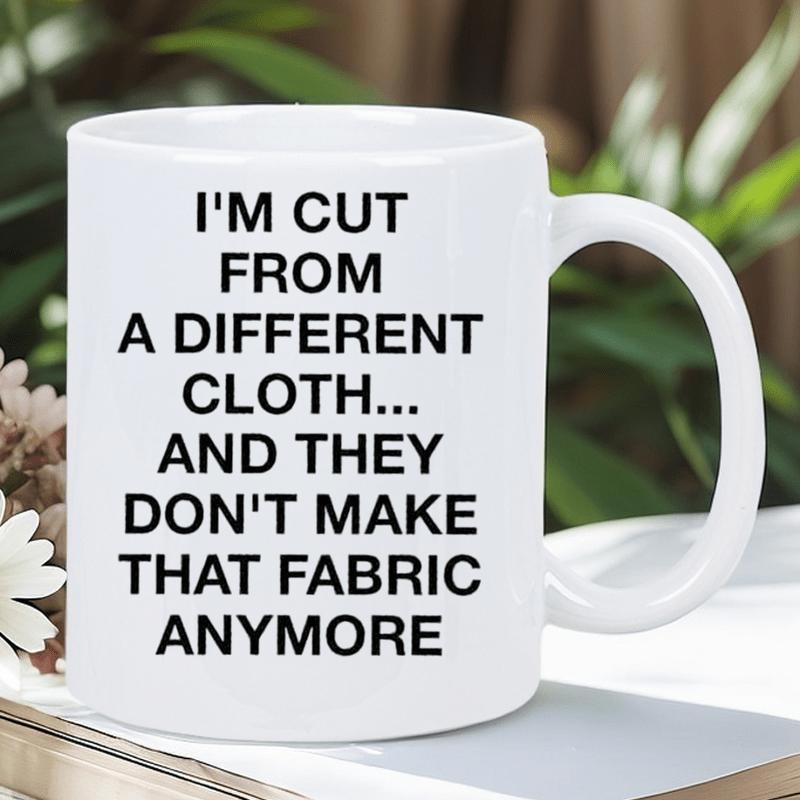 Tailorly White Ceramic 11 oz Mug - Im Cut From A Different Cloth And They Dont Make That Fabric Anymore Minimalist White Ceramic Vessel Resting Upon Book Among