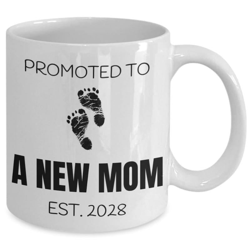 Tailorly White Ceramic 11 oz Mug - Promoted To A New Mom Est 2028 Minimalist Black Ink Style Tiny Newborn Baby Footprints