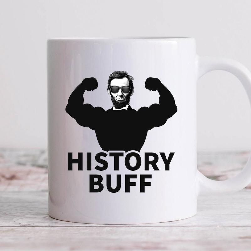 Tailorly White Ceramic 11 oz Mug - History Buff Muscular Bodybuilder Silhouette Wearing Modern Sunglasses Showing Strong Lincoln