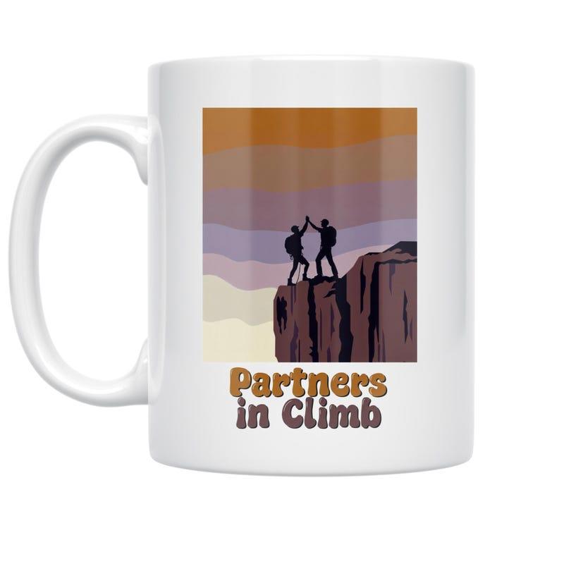 Tailorly White Ceramic 11 oz Mug - Partners In Climb Two Adventurous Hikers High Fiving Atop A Rugged Mountain Cliff Under Sunset Mountain