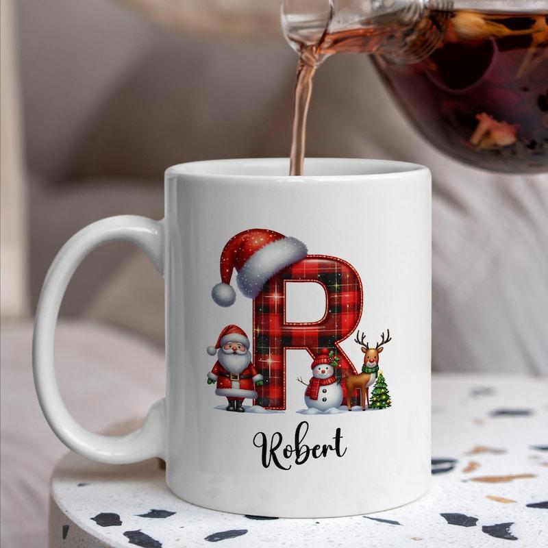Tailorly White Ceramic 11 oz Mug - Robert Festive Red Plaid Pattern With Santa Hat And Holiday Characters Letter