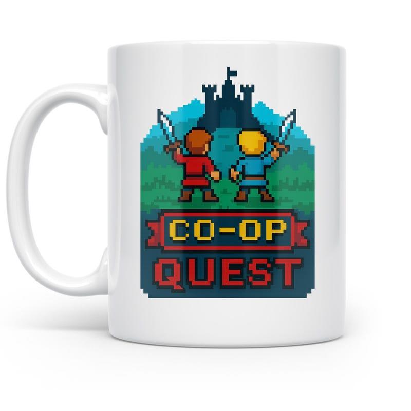 Tailorly White Ceramic 11 oz Mug - Co Op Quest Retro Pixel Heroes Holding Swords Before A Dark Distant Castle