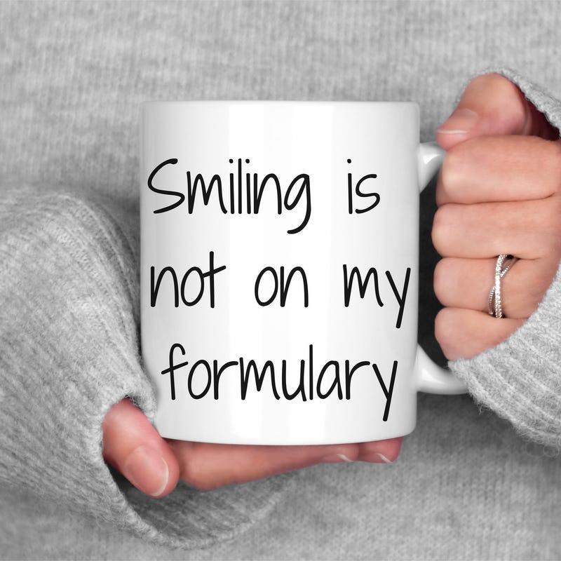 Tailorly White Ceramic 11 oz Mug - Smiling Is Not On My Formulary Simple Minimalist Style With Black Handwritten Text Centered Upon A Ceramic Mug