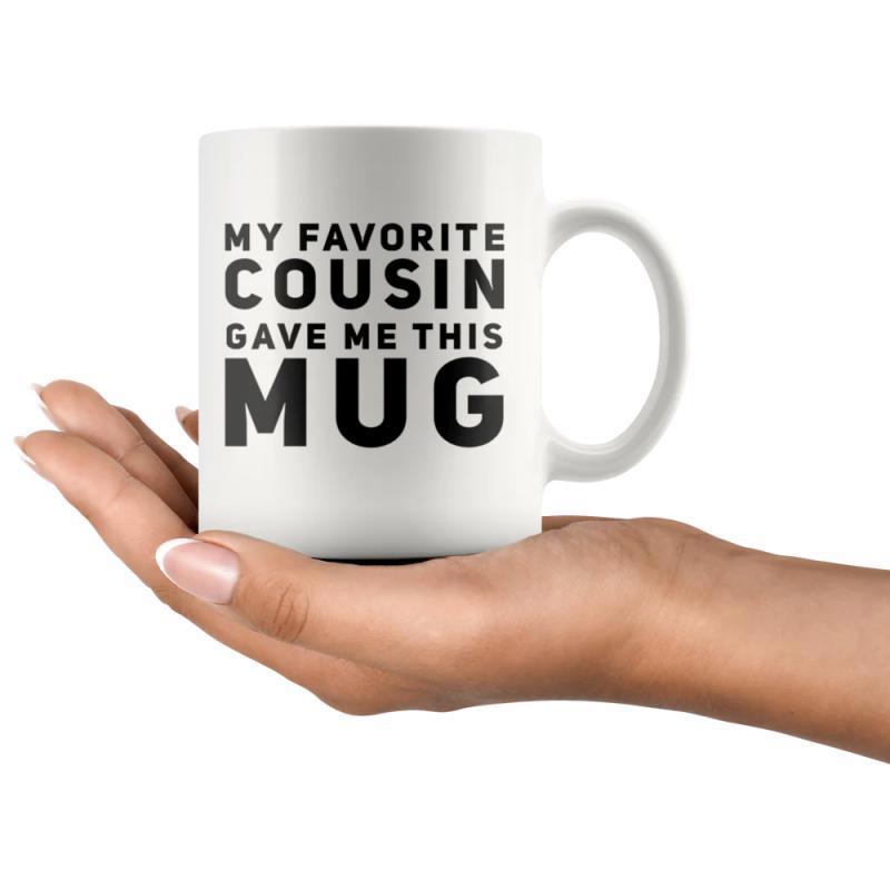Tailorly White Ceramic 11 oz Mug - My Favorite Cousin Gave Me This Mug Minimalist White Ceramic Vessel Held Gently By A Realistic Human Hand Mug