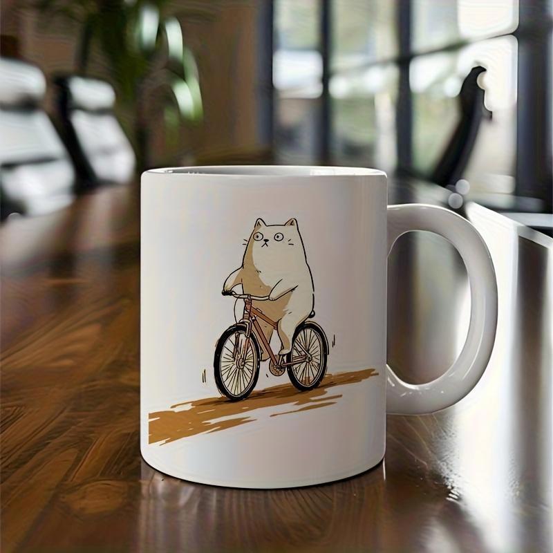 Tailorly White Ceramic 11 oz Mug - Chubby White Minimalist Feline Riding A Tiny Bicycle Along Brown Road Cat