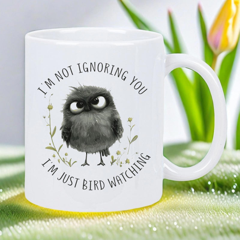 Tailorly White Ceramic 11 oz Mug - Im Not Ignoring You Im Just Bird Watching Cute Fluffy Black Bird With Large Expressive Eyes Standing Among Delicate Wildflower
