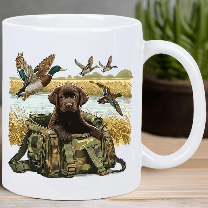 Tailorly White Ceramic 11 oz Mug - Adorable Brown Labrador Puppy Inside Camouflage Hunting Bag Near Flying Mallard Dog