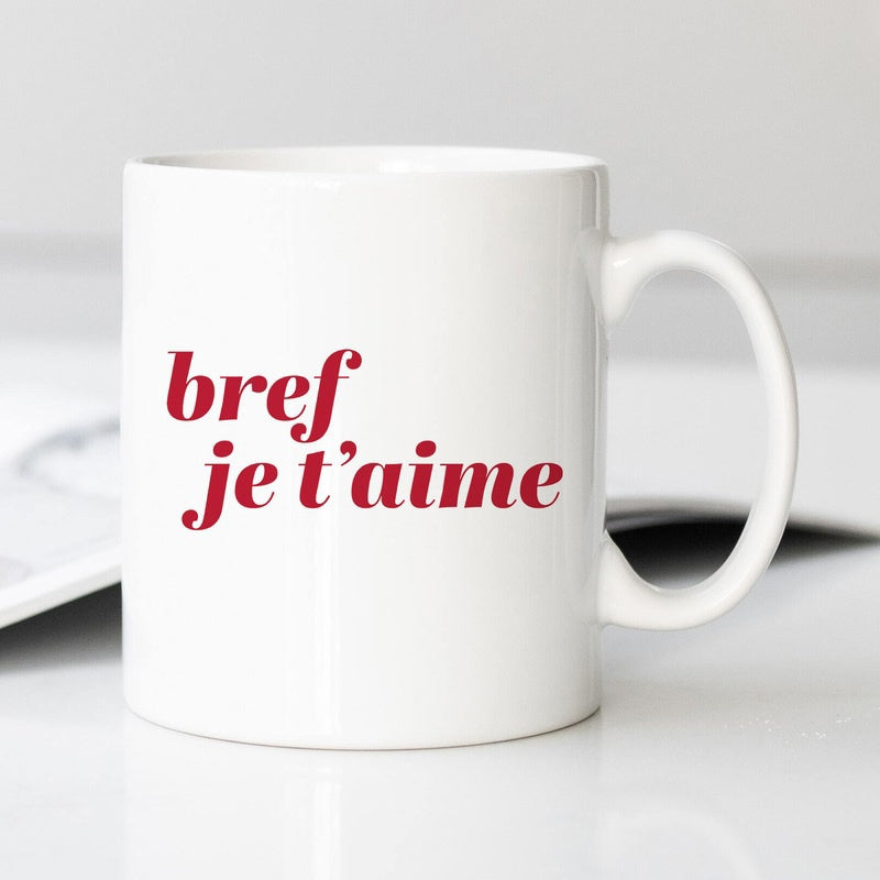 Tailorly White Ceramic 11 oz Mug - Minimalist White Ceramic Vessel Displaying Bold Red Script Under Soft Lighting Mug