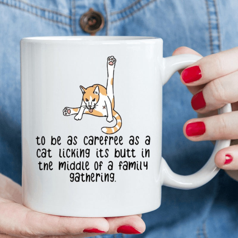 Tailorly White Ceramic 11 oz Mug - To Be As Carefree As A Cat Licking Its Butt In The Middle Of A Family Gathering Humorous Orange Tabby Cat Grooming Itself With