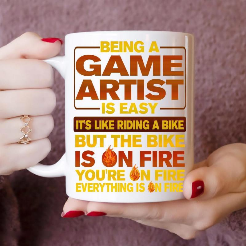 Tailorly White Ceramic 11 oz Mug - Being A Game Artist Is Easy Its Like Riding A Bike But The Bike Is On Fire Youre On Fire Everything Is On Fire Vibrant Stylized