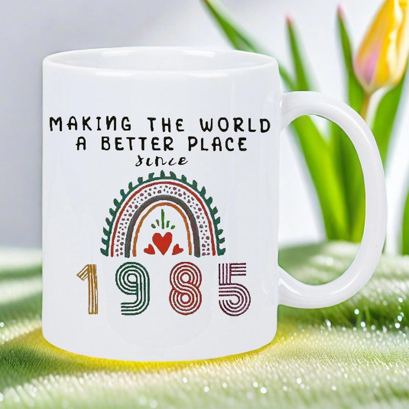 Tailorly White Ceramic 11 oz Mug - Making The World A Better Place Since 1985 Stylized Colorful Boho Rainbow Featuring Arches And A Central Heart Rainbow