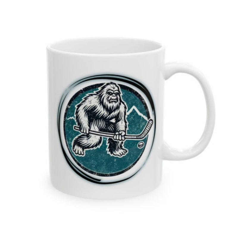 Tailorly White Ceramic 11 oz Mug - Hairy Sasquatch Holding Hockey Stick On Ice Near Snowy Mountain Peak Bigfoot