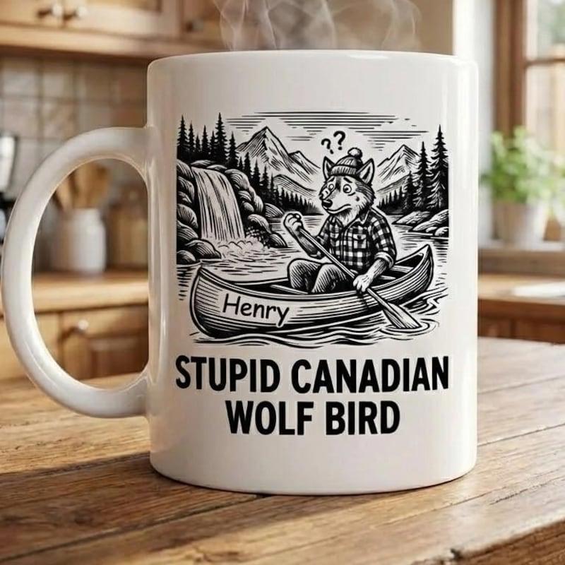 Tailorly White Ceramic 11 oz Mug - Henry Stupid Canadian Wolf Bird Funny Cartoon Animal Paddling Canoe Past Scenic Mountain Waterfall Wolf