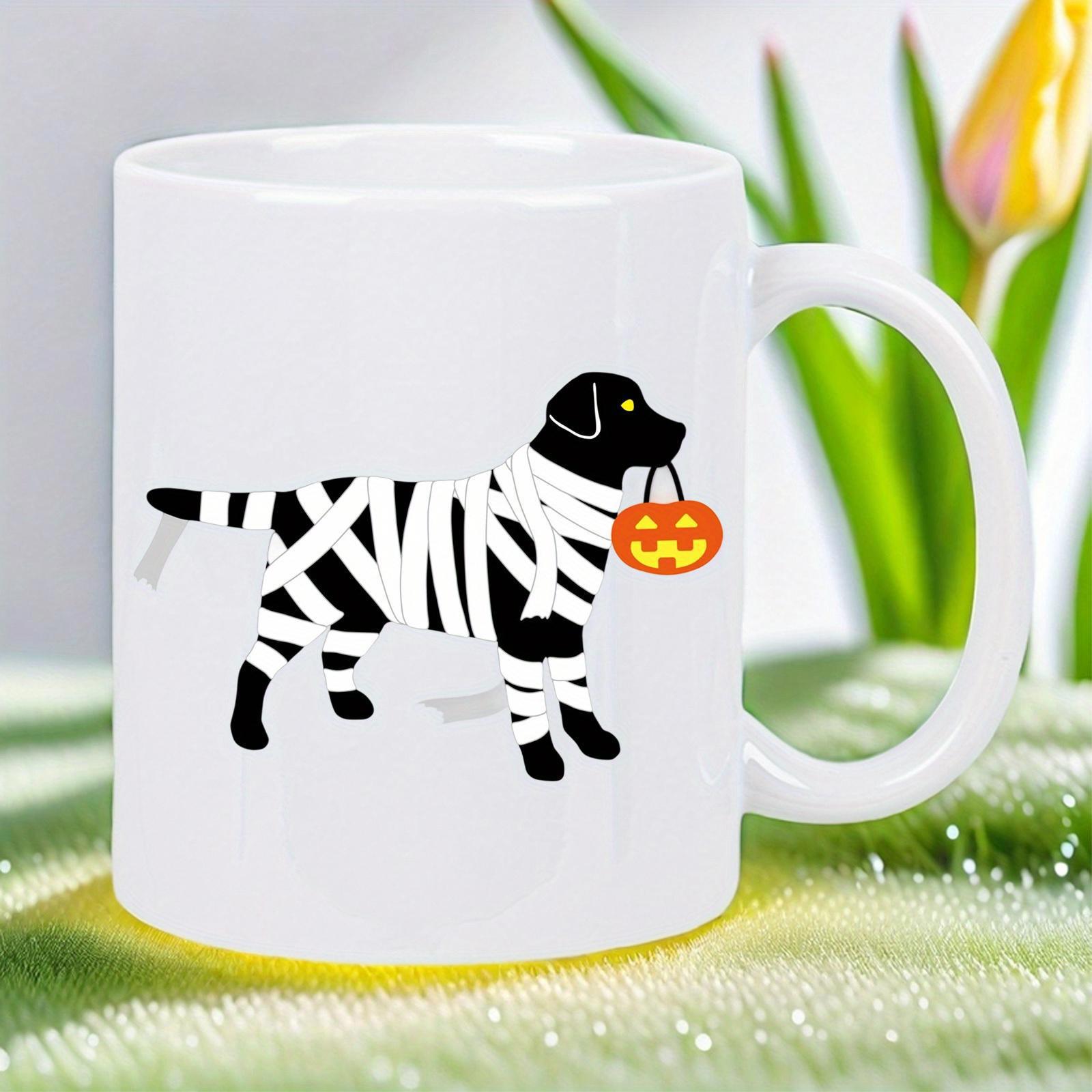 Tailorly White Ceramic 11 oz Mug - Black Dog Wrapped In White Mummy Bandages Carrying An Orange Pumpkin Bucket Dog