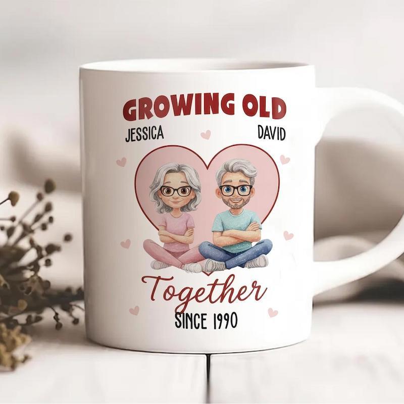 Tailorly White Ceramic 11 oz Mug - Growing Old Together Since 1990 Jessica David Cartoon Elderly Pair Sitting Within A Large Pink Heart Symbol Couple