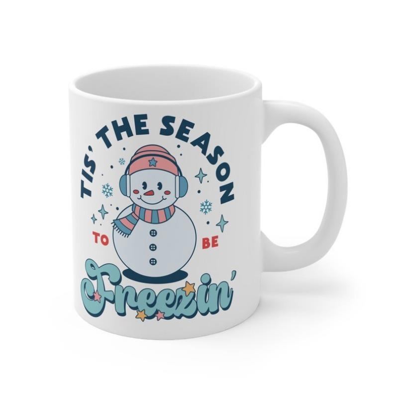Tailorly White Ceramic 11 oz Mug - Tis' The Season To Be Freezin' Cute Cartoon Character Wearing Scarf And Earmuffs Among Sparking Snowflakes Snowman