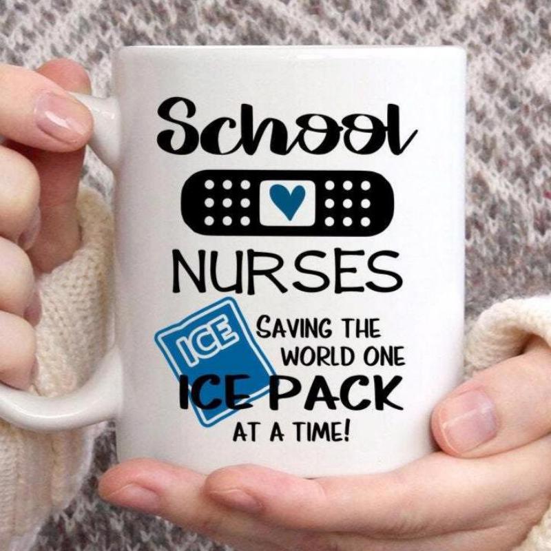 Tailorly White Ceramic 11 oz Mug - School Nurses Saving The World One Ice Pack At A Time Stylized Black Medical Bandage Featuring Small Blue Heart Decorative