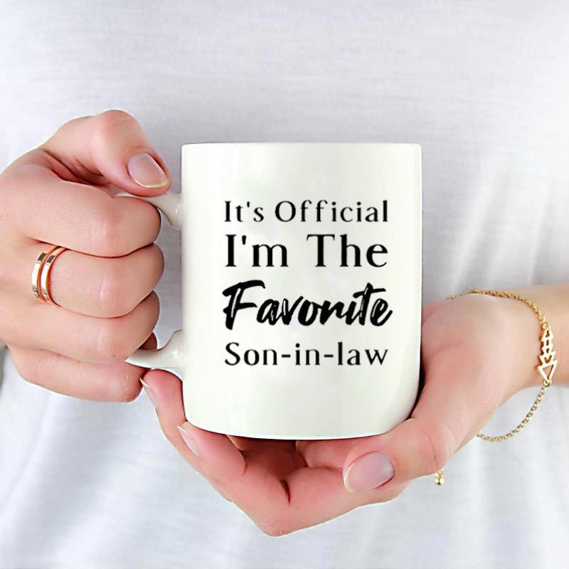 Tailorly White Ceramic 11 oz Mug - Its Official Im The Favorite Son In Law Classic White Ceramic Cup Held By Hands Featuring Bold Script Mug