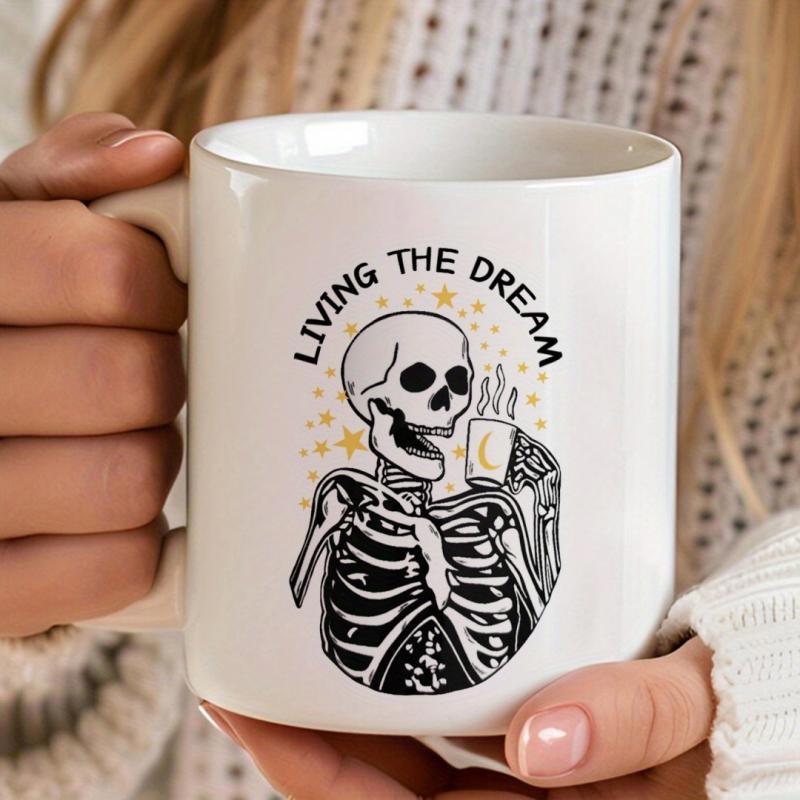 Tailorly White Ceramic 11 oz Mug - Living The Dream Skeletal Figure Holding Steaming Coffee Cup With Small Stars Skeleton