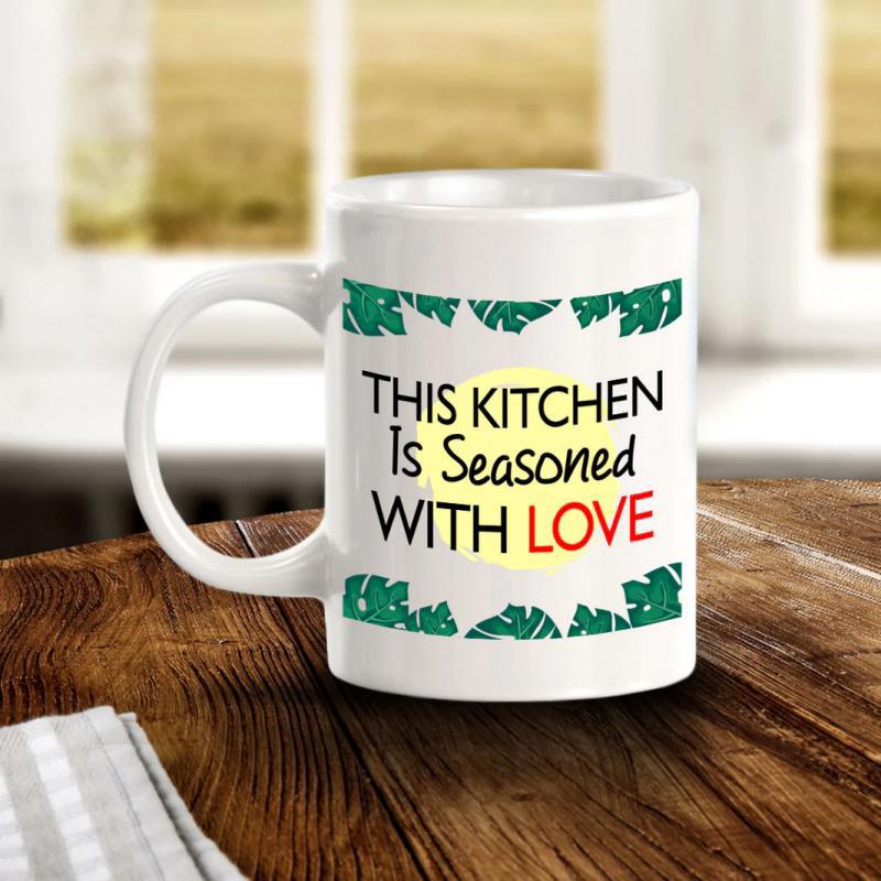 Tailorly White Ceramic 11 oz Mug - This Kitchen Is Seasoned With Love Green Tropical Monstera Leaves Bordering A Soft Yellow Glowing Sunlight Background Mug
