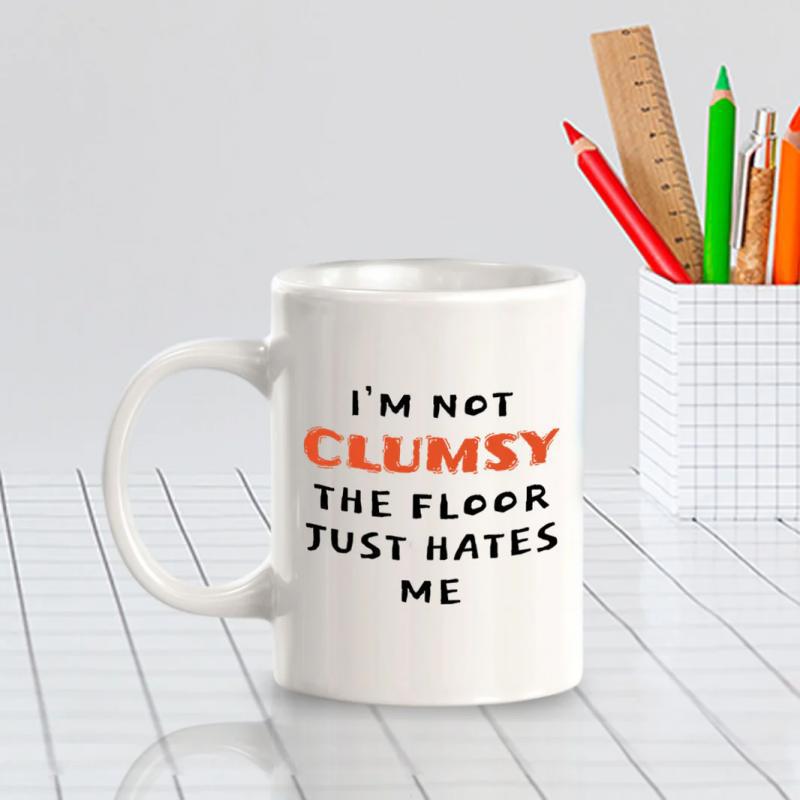 Tailorly White Ceramic 11 oz Mug - Im Not Clumsy The Floor Just Hates Me Bold Typography With Playful Orange And Black Lettering Quote