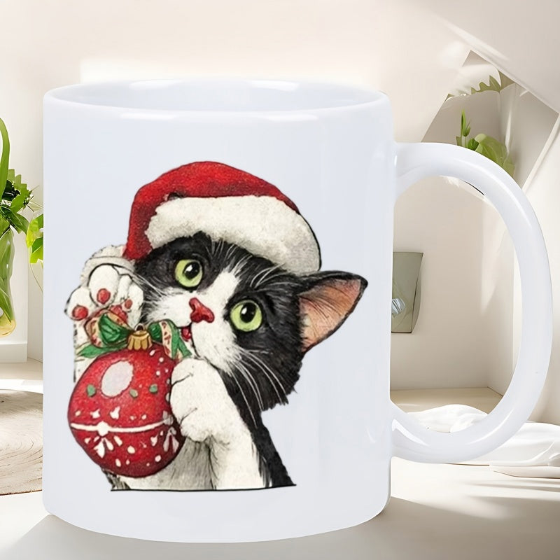 Tailorly White Ceramic 11 oz Mug - Festive Tuxedo Kitten Wearing Red Santa Hat Holding Decorative Christmas Bauble Cat