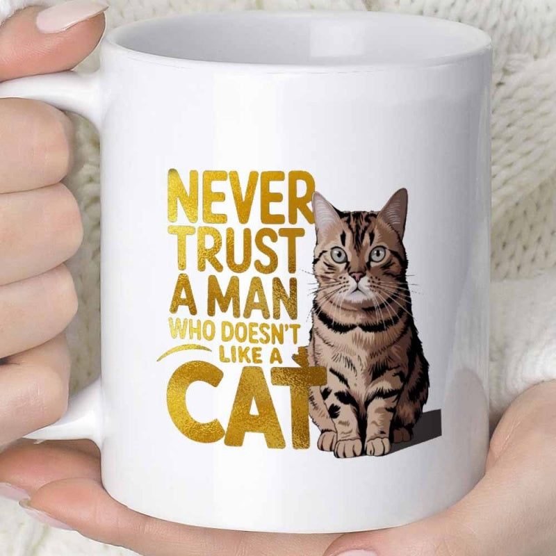 Tailorly White Ceramic 11 oz Mug - Never Trust A Man Who Doesn't Like A Cat Realistic Brown Tabby Sitting Calmly Beside Bold Golden Metallic Typography Cat