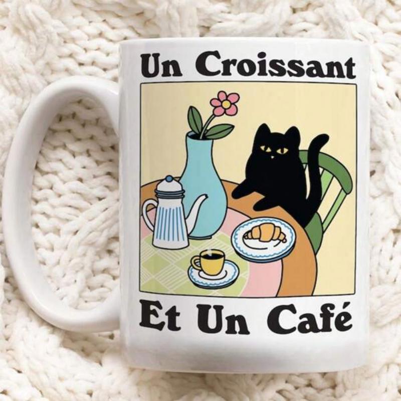 Tailorly White Ceramic 11 oz Mug - Charming Black Cat Sitting At Table With Hot Coffee And A Freshly Baked Croissant Cat