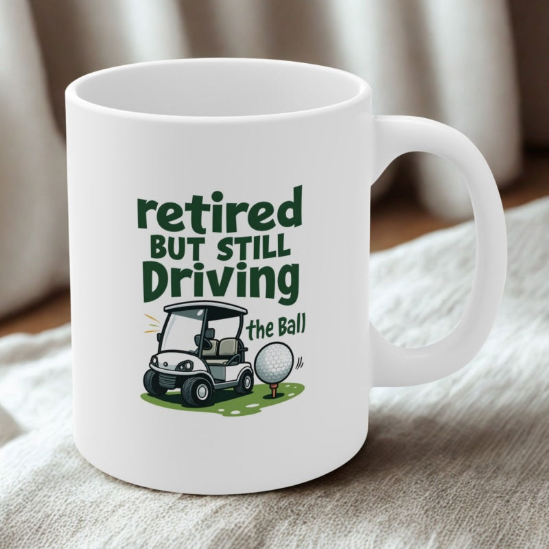 Tailorly White Ceramic 11 oz Mug - Retired But Still Driving The Ball Minimalist White Cartoon Vehicle Sitting On Green Grass Beside A Small Golf Cart