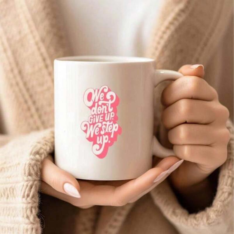 Tailorly White Ceramic 11 oz Mug - We Don't Give Up We Step Up Ceramic Coffee Vessel Held By Hands Featuring Pink Motivational Script Mug