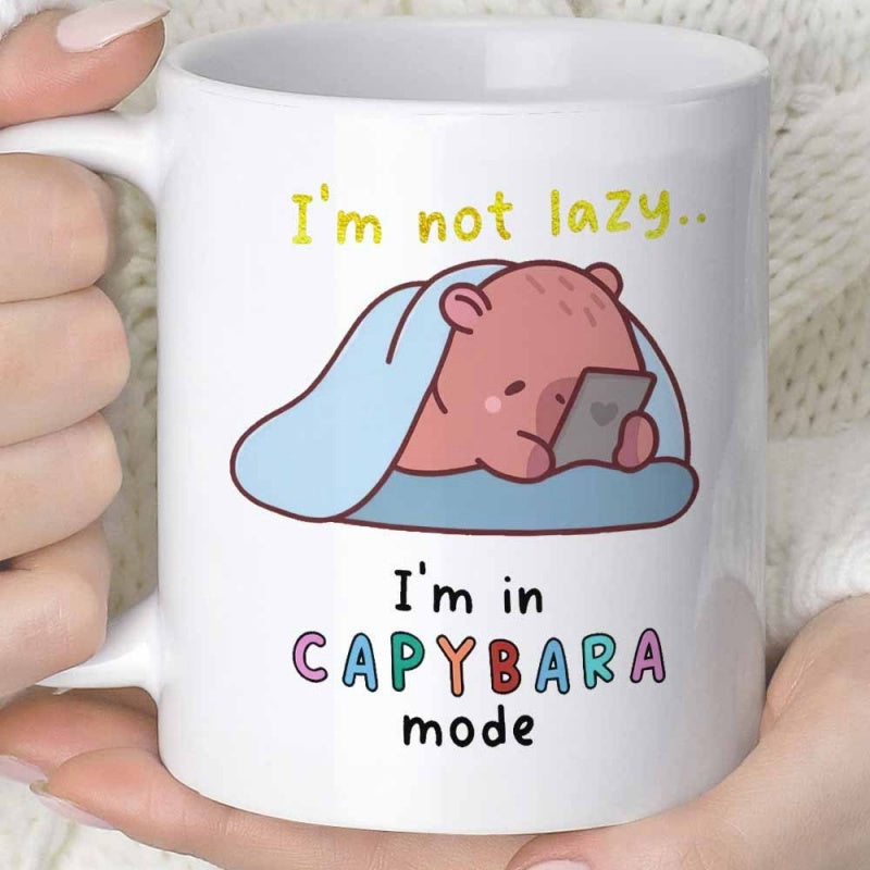 Tailorly White Ceramic 11 oz Mug - Im Not Lazy Im In Capybara Mode Adorable Chubby Animal Resting Under Cozy Blue Blanket Using Mobile Phone Capybara