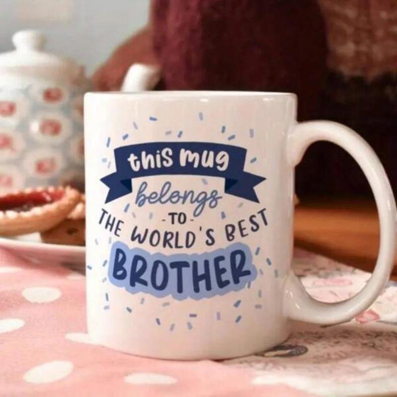 Tailorly White Ceramic 11 oz Mug - This Mug Belongs To The World's Best Brother Blue Banner With Confetti Dots Surrounding Playful Typography Mug