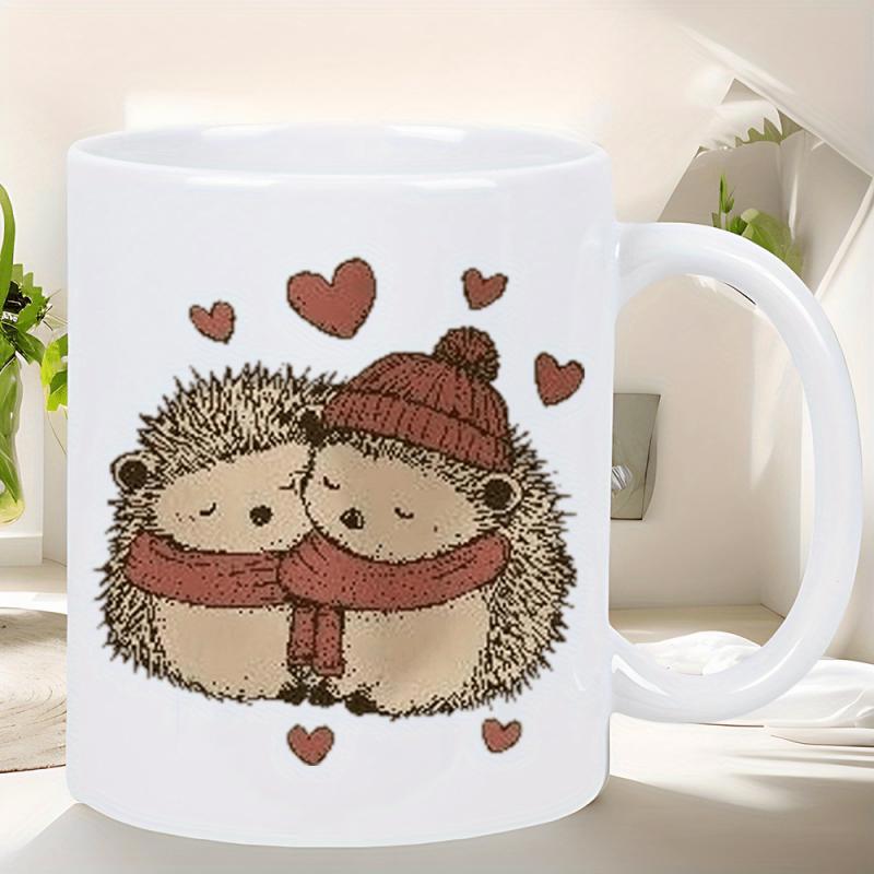 Tailorly White Ceramic 11 oz Mug - Cute Snuggling Couple Wearing Knitted Winter Accessories Under Floating Love Hearts Hedgehogs