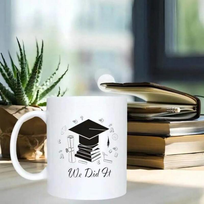 Tailorly White Ceramic 11 oz Mug - We Did It Graduation Cap Resting On Stack Of Academic Books Among Floating Icons Mug