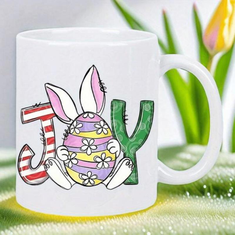 Tailorly White Ceramic 11 oz Mug - Joy Cute Festive Bunny Holding Patterned Easter Egg Between Colorful Letters Rabbit