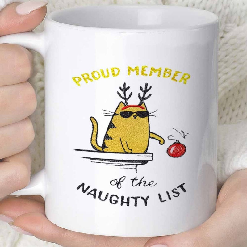 Tailorly White Ceramic 11 oz Mug - Proud Member Of The Naughty List Festive Ginger Cat Wearing Antlers Pushing Red Christmas Ornament Cat