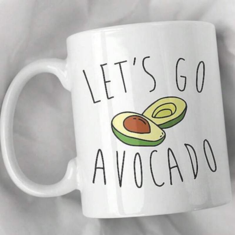 Tailorly White Ceramic 11 oz Mug - Lets Go Avocado Sliced Green Fruit Showing Pit Resting Gently Against White Ceramic Background Avocado