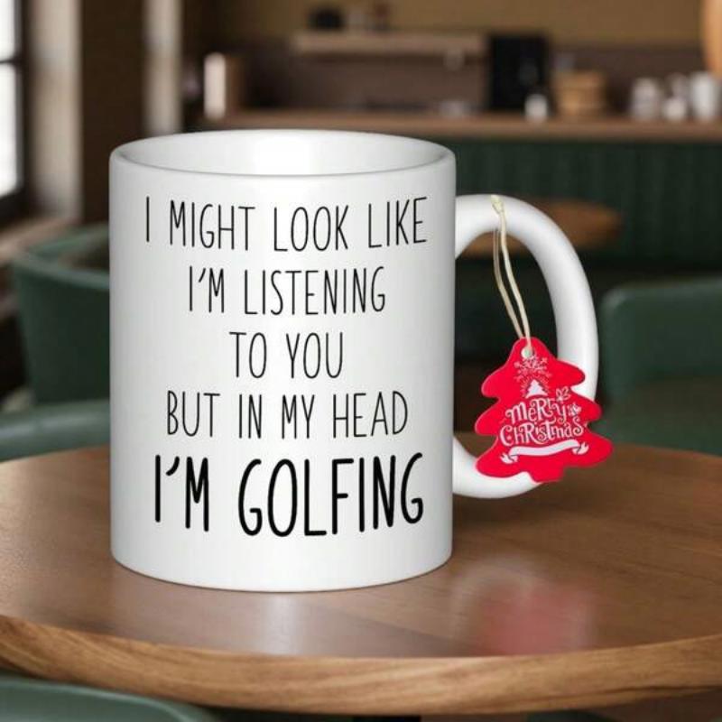 Tailorly White Ceramic 11 oz Mug - I Might Look Like I'm Listening To You But In My Head I'm Golfing Clean Black Typography Printed On Simple White Surface Mug