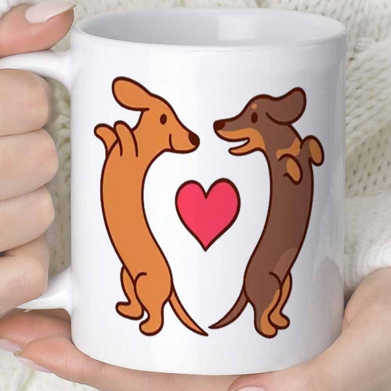 Tailorly White Ceramic 11 oz Mug - Two Playful Cartoon Sausage Dogs Standing Together Around A Small Red Heart Dachshund