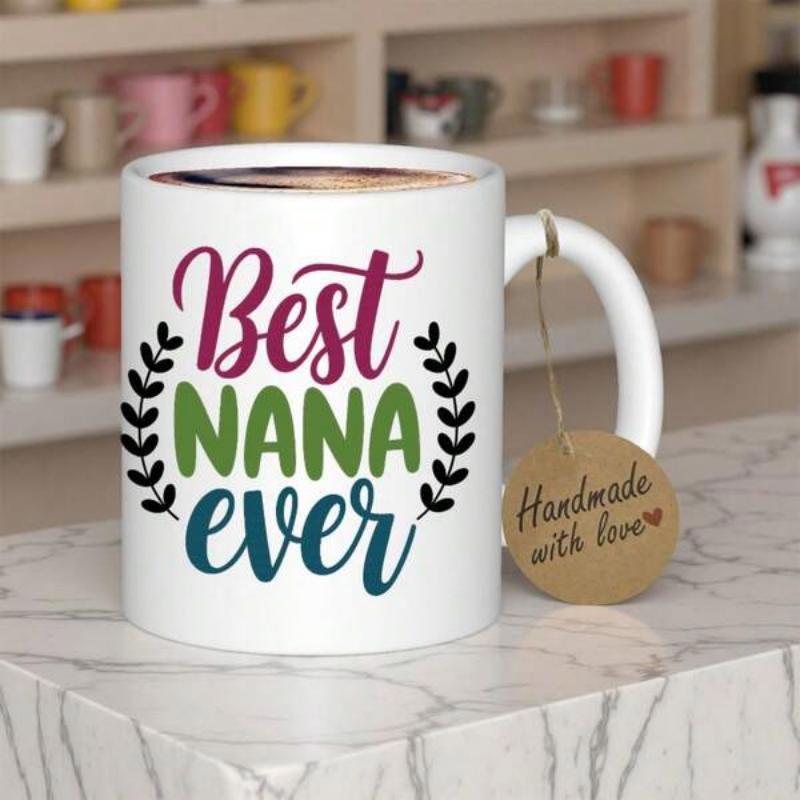 Tailorly White Ceramic 11 oz Mug - Best Nana Ever Symmetrical Leaf Icons Flanking Colorful Artistic Script On Smooth Ceramic Mug