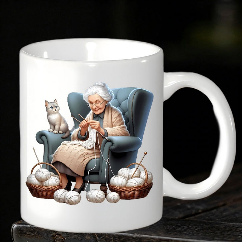Tailorly White Ceramic 11 oz Mug - Elderly Woman Knitting Yarn While Sitting In Armchair Beside Cat Grandmother