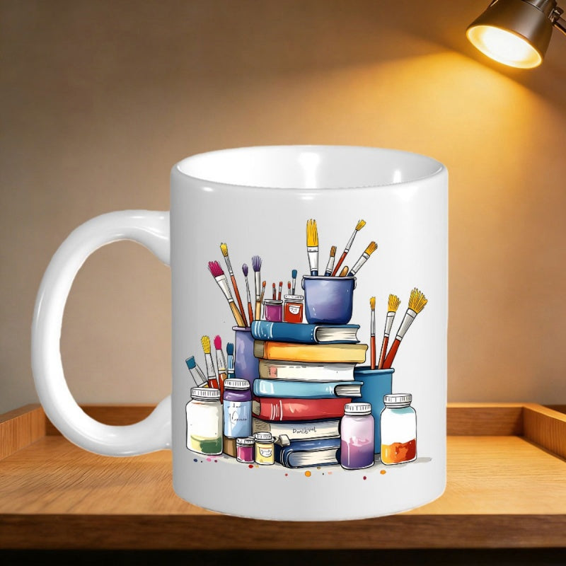 Tailorly White Ceramic 11 oz Mug - Vibrant Artistic Watercolor Paintbrushes And Jars Next To A Colorful Book Stack