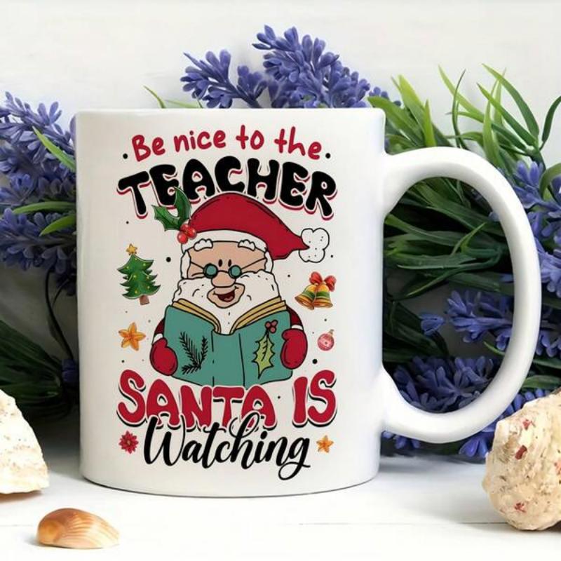 Tailorly White Ceramic 11 oz Mug - Be Nice To The Teacher Santa Is Watching Jolly Santa Holding Green Book Surrounded By Festive Christmas Tree And Bells Santa