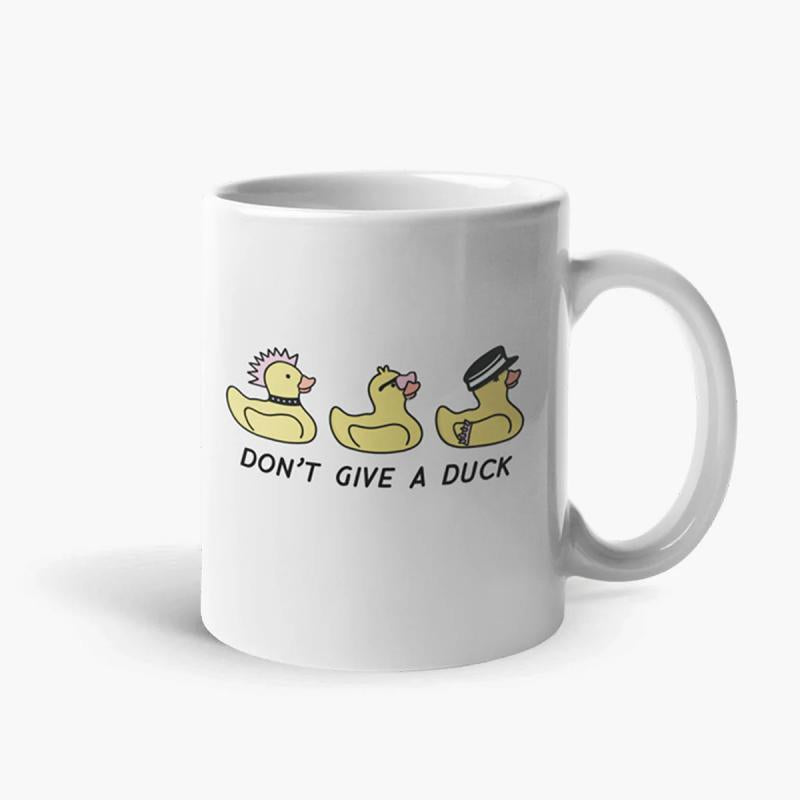 Tailorly White Ceramic 11 oz Mug - Don't Give A Duck Three Small Yellow Rubber Ducks Wearing Different Decorative Costumes And Accessories Duck