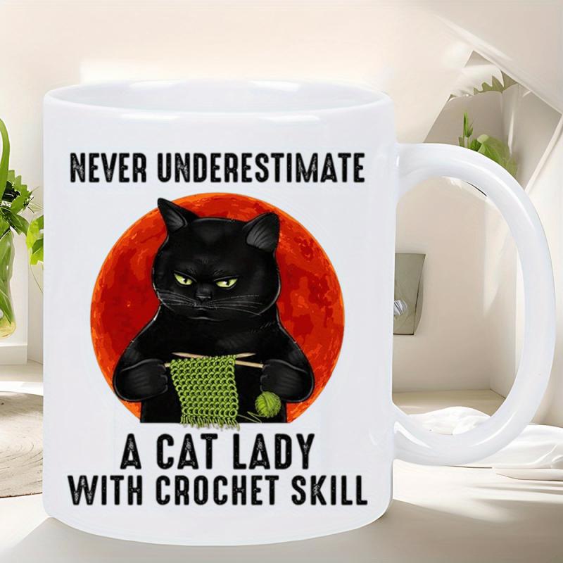Tailorly White Ceramic 11 oz Mug - Never Underestimate A Cat Lady With Crochet Skill Grumpy Black Cat Crocheting Green Yarn Against Large Vibrant Red Circular Moon