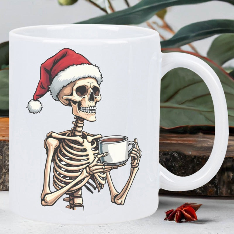Tailorly White Ceramic 11 oz Mug - Chilling Festive Holiday Character Wearing Red Santa Hat Holding Coffee Skeleton